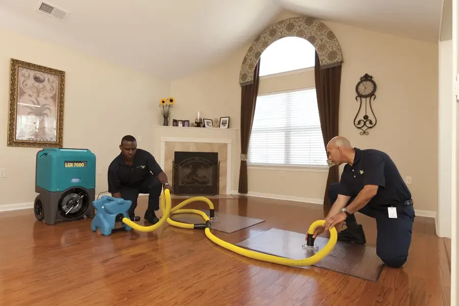 Technician extracting standing water from a Williamstown, NJ floor